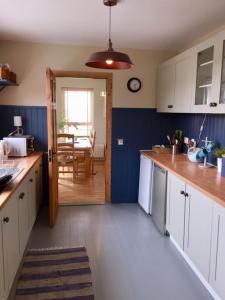 a kitchen with a door open to a dining room at Ballyboe Cottage in Dunfanaghy