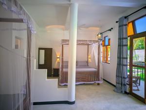 a bedroom with a bed in a room at Blue skies guest house and restaurant in Tangalle