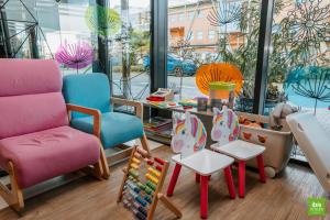 a room with chairs and tables in front of a window at ibis Styles Siedlce in Siedlce