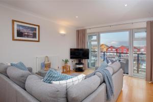 a living room with two couches and a television at Pilot Wharf in Exmouth