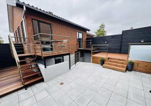 a patio with stairs and a brick building at Østerbrogade 49 in Holstebro