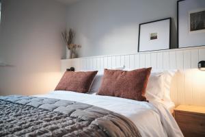 a bedroom with a large bed with brown pillows at The Crow's Nest Skye in Kensaleyre