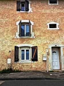 two windows and a door on the side of a building at Minimaliste 10min Futuroscope & Cœur de Poitiers in Buxerolles