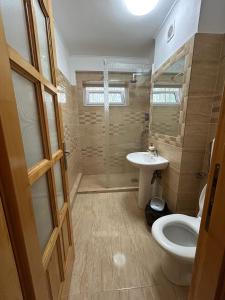 a bathroom with a toilet and a sink at Aparthotel Brasov Neptun in Braşov
