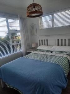 Un dormitorio con una cama grande y una ventana en StruisPlace, en Struisbaai 9 fotos más