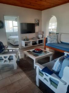 a living room with a couch and a table at StruisPlace in Struisbaai