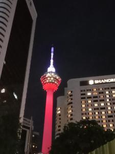 a lit up tower in a city at night at Vortex suites klcc by yana in Kuala Lumpur