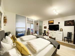 a living room with a white bed and a couch at Coresi Escape Studio in Sînpetru