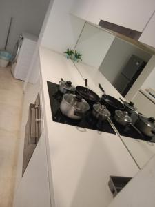 a kitchen with pots and pans on a stove at Vortex suites klcc by yana in Kuala Lumpur
