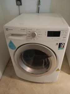 a white washing machine sitting in a room at Vortex suites klcc by yana in Kuala Lumpur