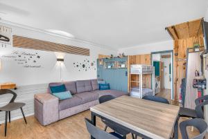 a living room with a couch and a table at Les Studios 27 et 28 in Superdevoluy