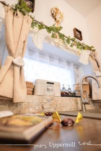 a kitchen with a counter with a sink and a counter top at Uppermill Suite #3 in Pécs