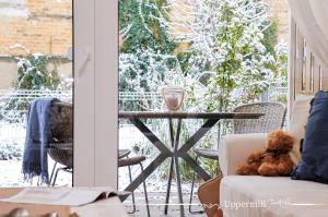 a teddy bear sitting on a couch on a porch with a table at Uppermill Suite #3 in Pécs +46 photos