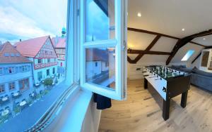 a room with a chess table and a large window at Juraperle - Historisch und modern - Wohnung 2 in Bad Staffelstein