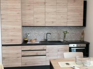 a kitchen with wooden cabinets and a wooden table at Suite Petit in Vairano Scalo +18 photos