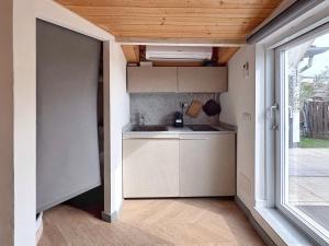 a small kitchen with a sink and a window at Terrazza57 in Centro Storico in Ferrara