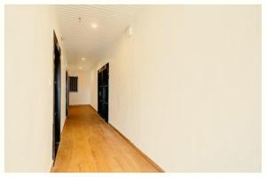 an empty hallway with white walls and a wooden floor at Hotel Ganraj Residency Near Laxmi Temple in Shirdi