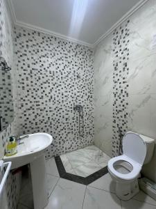 a bathroom with a toilet and a sink and a shower at Spacious Apartment in heart of Agadir in Agadir