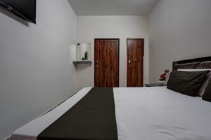 Ένα ή περισσότερα κρεβάτια σε δωμάτιο στο Hotel O VS GALAXY