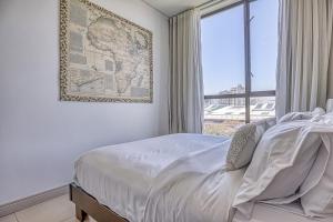 a bedroom with a bed with a map on the wall at Casa Vista One Rosebank in Johannesburg
