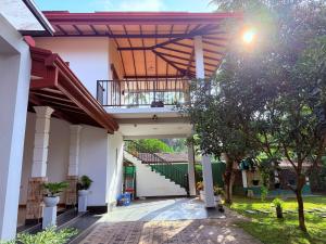 a courtyard of a building with a balcony at Transit villa 10 minutes drive from the Airport in Katunayake