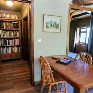 a dining room with a wooden table and chairs at Halls Cleave, Woodland Retreat, Moretonhampstead, Dartmoor in Moretonhampstead
