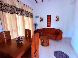 a bathroom with a tub and a table and a wooden table at Transit villa 10 minutes drive from the Airport in Katunayake