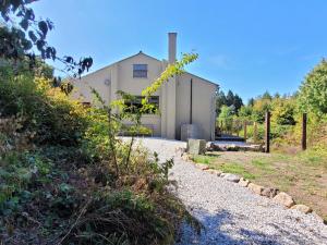 a white house with a pathway in front of it at Halls Cleave, Woodland Retreat, Moretonhampstead, Dartmoor in Moretonhampstead