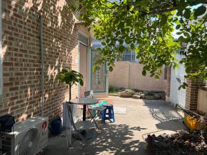 a small patio with a table and a window at Harry House in Gyeongju