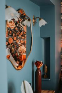 a mirror hanging on a wall in a room at Hotel de la Gaichel in Eischen