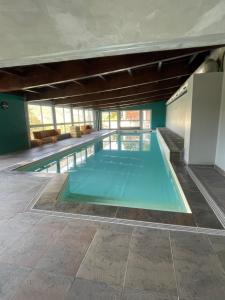 a large swimming pool in a building at T3 Terrasse Piscine Sauna Spa Jausiers Magnans in Jausiers