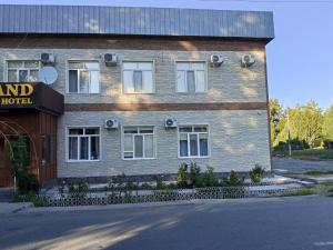 a brick building with a sign on the side of it at Сарканд in Sarqan