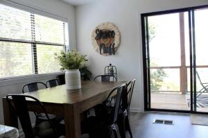 a dining room with a wooden table and chairs at Shore Nuff a relaxing 4-bedroom vacation home on Canyon Lake in Canyon Lake