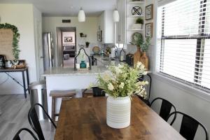 a kitchen with a table with a vase of flowers on it at Shore Nuff a relaxing 4-bedroom vacation home on Canyon Lake in Canyon Lake +13 photos
