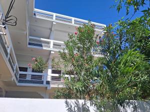 a balcony of a building with trees and flowers at Beach life long beach resort in Trincomalee