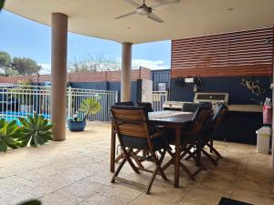 a patio with a table and chairs on a patio at Gecko Lodge Kalbarri in Kalbarri