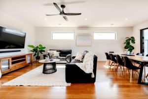 a living room with a couch and a table at Spacious Seaview Family Getaway in Torquay