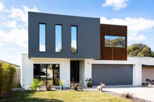 a house with a dog in front of it at Spacious Seaview Family Getaway in Torquay