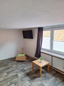 a living room with a table and a tv at Monteurzimmer 1 Brinckmann in Einbeck
