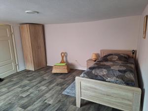 a bedroom with a bed and a wooden floor at Monteurzimmer 1 Brinckmann in Einbeck