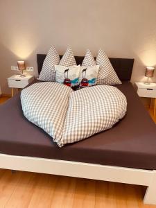 a large bed with pillows on top of it at Ferienwohnung Auszeit in Kirchdorf in Tirol