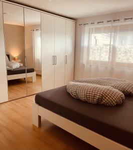 a bedroom with a bed and a mirror at Ferienwohnung Auszeit in Kirchdorf in Tirol