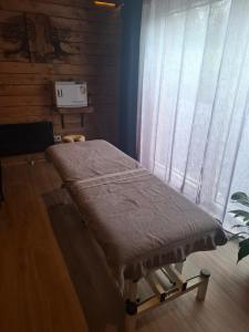 a hospital bed in a room with a window at Chambre spa eden in Sainte-Ode
