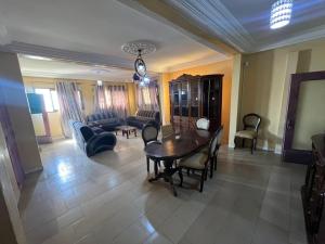 a large living room with a table and chairs at Teranga Sénégal Chez Mimi in Toubab Dialaw