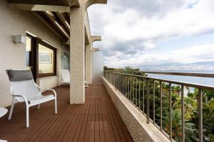 a balcony with a chair and a view of the water at Reggio Suite in Reggio Calabria