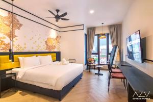 a hotel room with a bed and a desk at 22 Macalisterz by ALV in George Town
