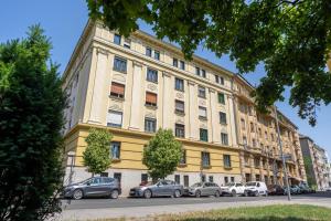 a large yellow building with cars parked in front of it at Castle Horizon Suite in Budapest