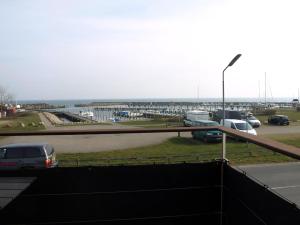 a view of a parking lot with cars parked at Super Apartment In The First Row With A 180-Degree Sea View in Spodsbjerg