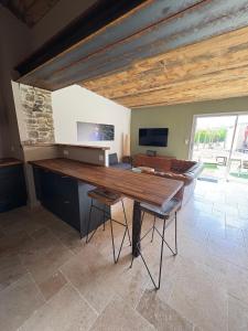 a large room with a wooden table and chairs at Le Chai des Poilanes in Liré