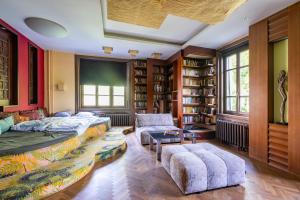 a bedroom with a bed and a couch and chairs at Castle Horizon Suite in Budapest
